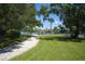 Scenic view along a gravel walking path with benches and views of the waterfront at 6415 Midnight Pass Rd # 508, Sarasota, FL 34242