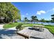 Scenic waterfront park featuring picnic tables, lush greenery, and serene water views at 6415 Midnight Pass Rd # 508, Sarasota, FL 34242