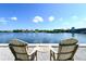 Relaxing waterfront view from the Adirondack chairs, offering serene views of the water at 6415 Midnight Pass Rd # 508, Sarasota, FL 34242