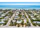 Scenic aerial view of a vibrant coastal neighborhood with lush greenery and beach access at 6606 Holmes Blvd # 3, Holmes Beach, FL 34217