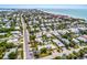 Stunning aerial view of a coastal neighborhood showcasing homes, palm trees, and the Gulf of Mexico at 6606 Holmes Blvd # 3, Holmes Beach, FL 34217