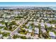 Scenic aerial view of a residential area with lush greenery, houses, and the Intracoastal Waterway at 6606 Holmes Blvd # 3, Holmes Beach, FL 34217