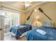 Cozy bedroom features two twin beds with nautical decor and access to a balcony with outdoor seating at 6606 Holmes Blvd # 3, Holmes Beach, FL 34217