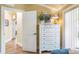 Bright bedroom featuring a six-drawer dresser, complemented by a nautical-themed lamp, and neutral decor at 6606 Holmes Blvd # 3, Holmes Beach, FL 34217