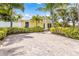 Charming yellow home with lush landscaping, brick drive, and sunny curb appeal at 6606 Holmes Blvd # 3, Holmes Beach, FL 34217