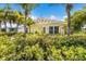 Inviting yellow home with well-manicured landscaping and tropical foliage at 6606 Holmes Blvd # 3, Holmes Beach, FL 34217