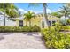 Attractive yellow home with lush landscaping, a brick driveway, and a welcoming entrance at 6606 Holmes Blvd # 3, Holmes Beach, FL 34217