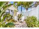 Inviting brick patio with tropical plants offering a serene outdoor space at 6606 Holmes Blvd # 3, Holmes Beach, FL 34217