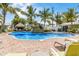 Resort-style pool with waterfall feature surrounded by lush landscaping and lounge chairs at 6606 Holmes Blvd # 3, Holmes Beach, FL 34217