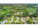 Expansive aerial view of a verdant community with lush trees and a beautiful golf course at 6624 Fairway Dr, Sarasota, FL 34243