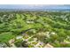 Scenic aerial shot showcases the golf course community, complete with water views and lush greenery at 6624 Fairway Dr, Sarasota, FL 34243