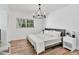 Bedroom with wood floors, natural light, and a decorative chandelier at 6624 Fairway Dr, Sarasota, FL 34243