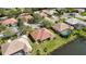 Spacious property featuring lush landscaping, bordering a tranquil lake, with nearby properties and serene street views at 6637 Deering Cir, Sarasota, FL 34240