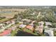 Spacious home next to a pond, with a red-tiled roof surrounded by lush landscaping in a quiet neighborhood at 6637 Deering Cir, Sarasota, FL 34240