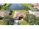 Home aerial with tile roof, green lawn, near a serene lake at 6637 Deering Cir, Sarasota, FL 34240