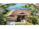 Aerial shot of home with tiled roof and lake view at 6637 Deering Cir, Sarasota, FL 34240