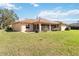 Spacious backyard with lush green grass and a peek at the screened in patio at 6637 Deering Cir, Sarasota, FL 34240