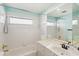 Bright bathroom featuring a shower-tub combo and a vanity with a white countertop sink at 6637 Deering Cir, Sarasota, FL 34240