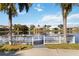 Community dock for serene lakeside enjoyment, framed by palm trees at 6637 Deering Cir, Sarasota, FL 34240