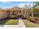 Inviting front entrance with decorative columns and a charming wooden door, surrounded by landscaped gardens at 6637 Deering Cir, Sarasota, FL 34240