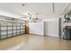 Well-lit garage with epoxy floors, storage cabinets, and garage door opener at 6637 Deering Cir, Sarasota, FL 34240