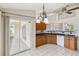 Bright kitchen features wood cabinetry, views to the lanai, and sleek black countertops at 6637 Deering Cir, Sarasota, FL 34240