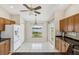 Eat-in kitchen features wood cabinets, neutral tile flooring, and a bright view of the lake at 6637 Deering Cir, Sarasota, FL 34240