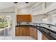 Well-lit kitchen with wood cabinets, a sink, and views to the outside lanai at 6637 Deering Cir, Sarasota, FL 34240