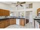 Kitchen with wooden cabinets, stainless appliances, and unique architectural design at 6637 Deering Cir, Sarasota, FL 34240