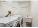 Bright laundry room features a utility sink, washer, dryer, and wire shelving at 6637 Deering Cir, Sarasota, FL 34240