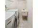 Laundry area with side-by-side washer and dryer and a utility sink at 6637 Deering Cir, Sarasota, FL 34240