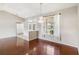 Bright and open living room featuring gleaming hardwood floors, a stylish chandelier, and large windows at 6637 Deering Cir, Sarasota, FL 34240