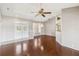 Open living room with a ceiling fan, hardwood floors, and a view of the front entry and backyard at 6637 Deering Cir, Sarasota, FL 34240