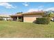 Rear exterior view featuring a screened lanai with neutral stucco and lawn at 6637 Deering Cir, Sarasota, FL 34240