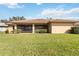 Screened lanai of home with tile roof, stucco walls and green lawn at 6637 Deering Cir, Sarasota, FL 34240