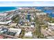 Aerial view of a coastal community featuring residential buildings, a calm pond, and beach access at 6640 Peacock Rd, Sarasota, FL 34242