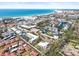 Overhead shot showcases a neighborhood near a tranquil beach, highlighting the coastal lifestyle at 6640 Peacock Rd, Sarasota, FL 34242