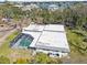 Aerial view of a screen enclosed pool on a large property with mature trees at 6640 Peacock Rd, Sarasota, FL 34242