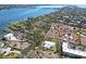 Stunning aerial view of waterfront property with lush landscaping and a glimpse of neighboring homes at 6640 Peacock Rd, Sarasota, FL 34242