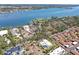 Expansive aerial view of a waterfront home site with lush landscaping, beautiful waterfront views and neighboring properties at 6640 Peacock Rd, Sarasota, FL 34242