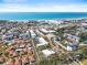 Scenic overhead view of homes in a coastal town, with the beach visible in the distance at 6640 Peacock Rd, Sarasota, FL 34242