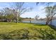 Expansive backyard with green grass and partial view of a block wall at 6640 Peacock Rd, Sarasota, FL 34242