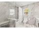 Beautiful renovated bathroom with large, grey tile, glass shower enclosure, and built in bench at 6640 Peacock Rd, Sarasota, FL 34242