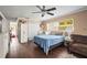 Bedroom with dark wood floors, a crib and large window at 6640 Peacock Rd, Sarasota, FL 34242