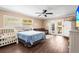 Bedroom with dark wood floors, couch and a crib at 6640 Peacock Rd, Sarasota, FL 34242