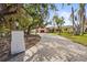 Long brick driveway leading to a well-maintained home, surrounded by mature trees and greenery at 6640 Peacock Rd, Sarasota, FL 34242