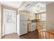 Kitchen with wooden cabinets, laminate countertops, and a white refrigerator near the door at 6640 Peacock Rd, Sarasota, FL 34242