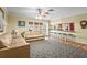 Bright living room with tan tile flooring, barstool seating and open to kitchen at 6640 Peacock Rd, Sarasota, FL 34242