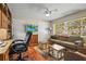 Relaxing living area featuring a TV, hardwood floors, and cozy seating, perfect for a home office at 6640 Peacock Rd, Sarasota, FL 34242