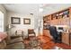 Cozy living room area featuring hardwood floors, custom built-in shelving, and comfortable seating at 6640 Peacock Rd, Sarasota, FL 34242